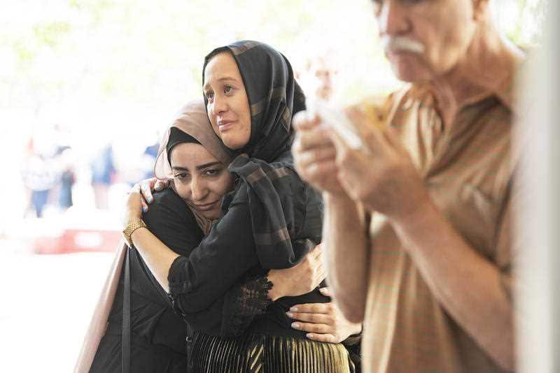 People hug during the open day at the Australian Islamic Centre in Newport, Melbourne.