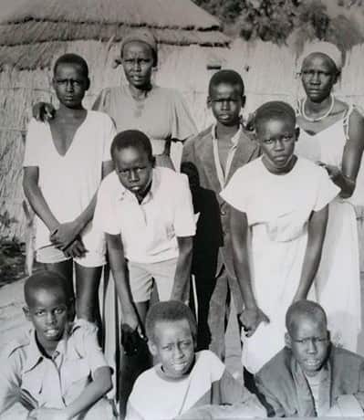 Yuot (bottom left) and his mother (top - second form left) at Pinyudu refugee camp.  