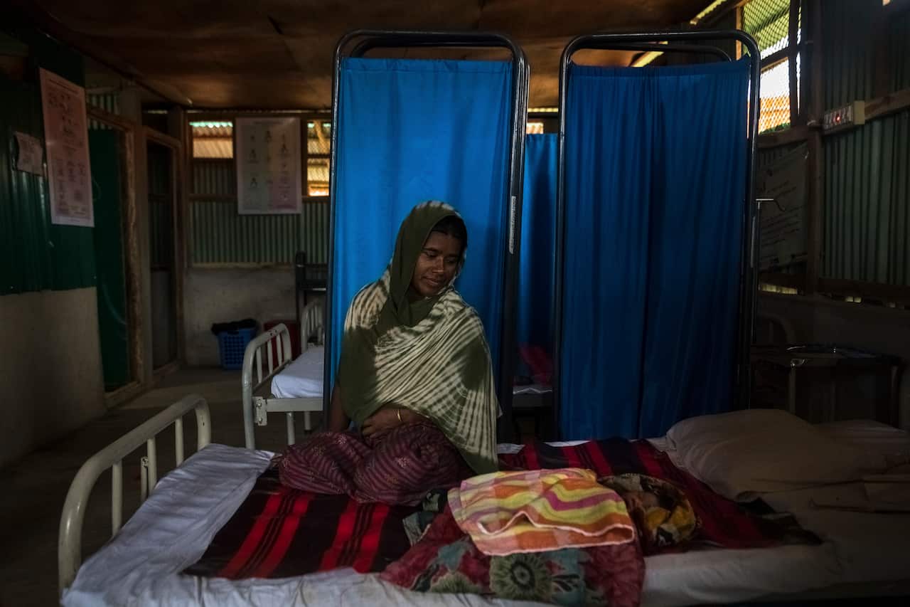 Minora Begum sits with her daughter, who was born the previous night, at the RTMI Women Wellbeing Center in the Kutupalong refugee camp in Bangladesh.
