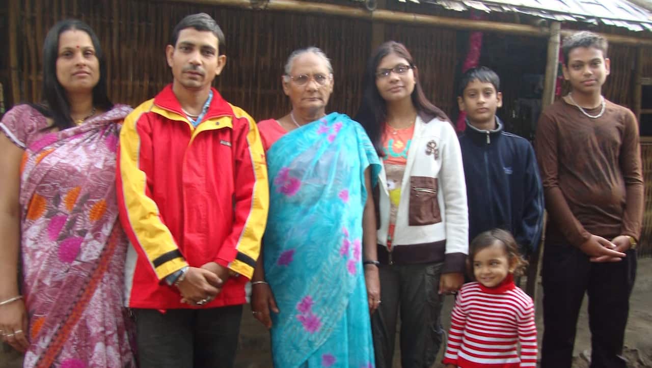 Manorath Sharma with his family in their refugee camp.