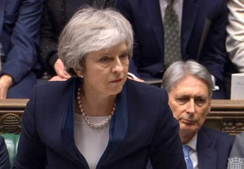 Prime Minister Theresa May reacts after MPs announce the result.