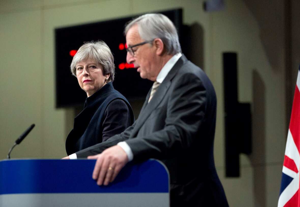  European Commission President Jean-Claude Juncker, right, and British Prime Minister Theresa May address a media conference at EU headquarters