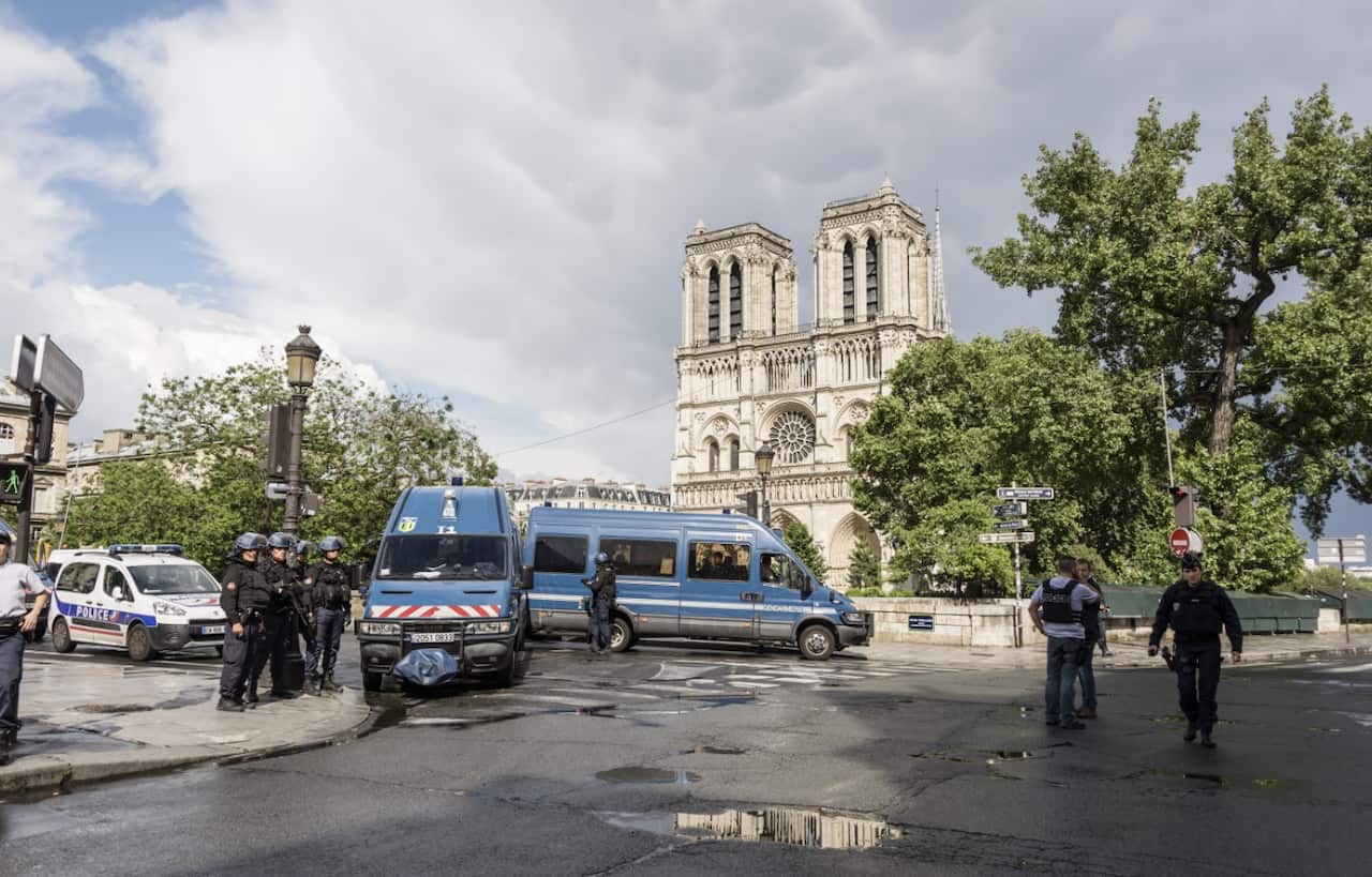 French police officials gather near the site of an attack at the entrance of Notre-Dame cathedral in Paris on June 6, 2017. (AAP)