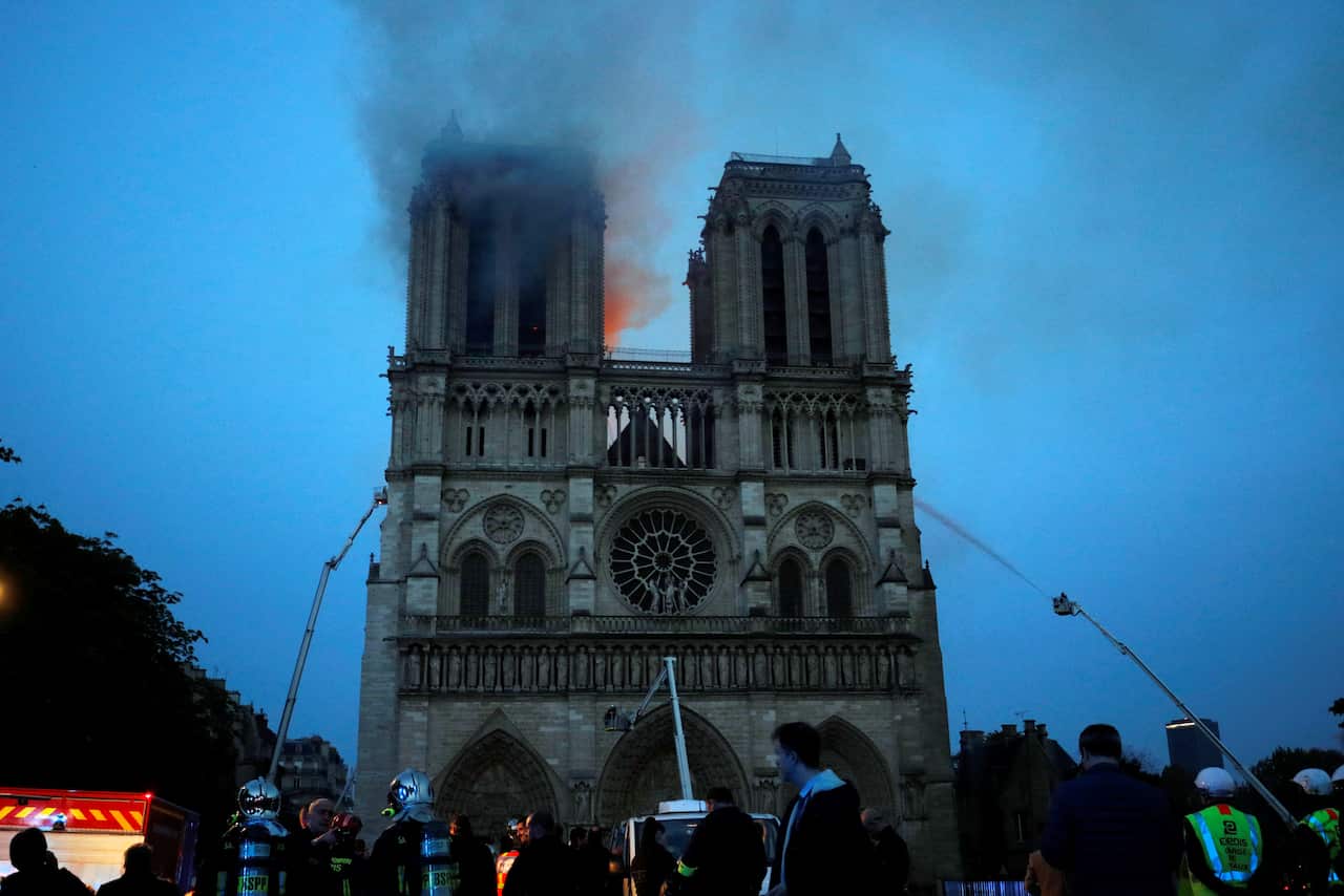 Firefighters train their hoses on Notre Dame Cathedral in Paris on Monday night, April 15, 2019. 