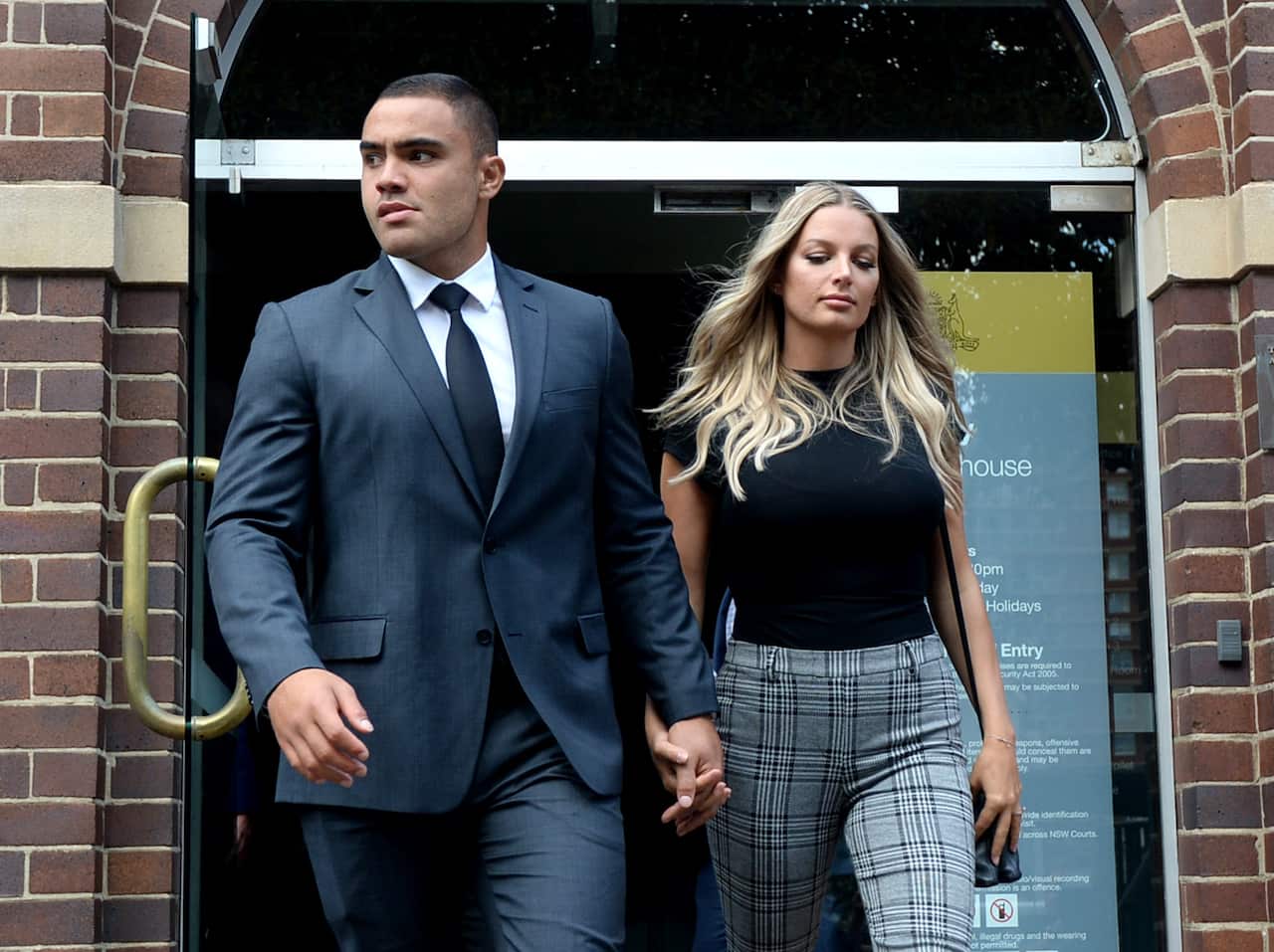 Manly Sea Eagles NRL player Dylan Walker (front left) and fiancé Alexandra Ivkovic (front right) leave Manly Court.