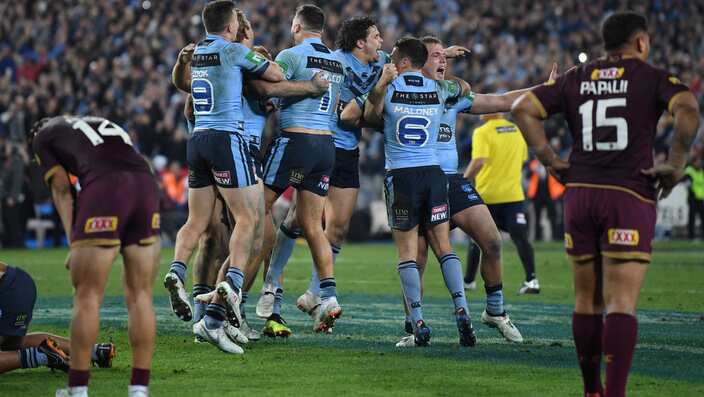 NSW Blues players celebrate winning Game 2 of the 2018 State of Origin series.