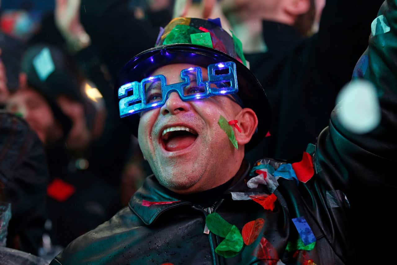 A reveler celebrates as confetti falls during a celebration of the new year in New York's Times Square.