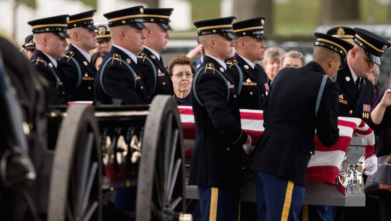 Officials carry the casket remains of a US soldier from the Korean War (AAP)