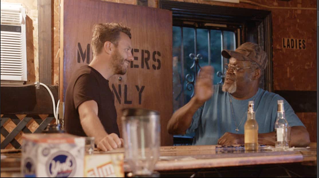 Reporter Dean Cornish (L) talking to a local at a bar in Youngstown, Ohio.