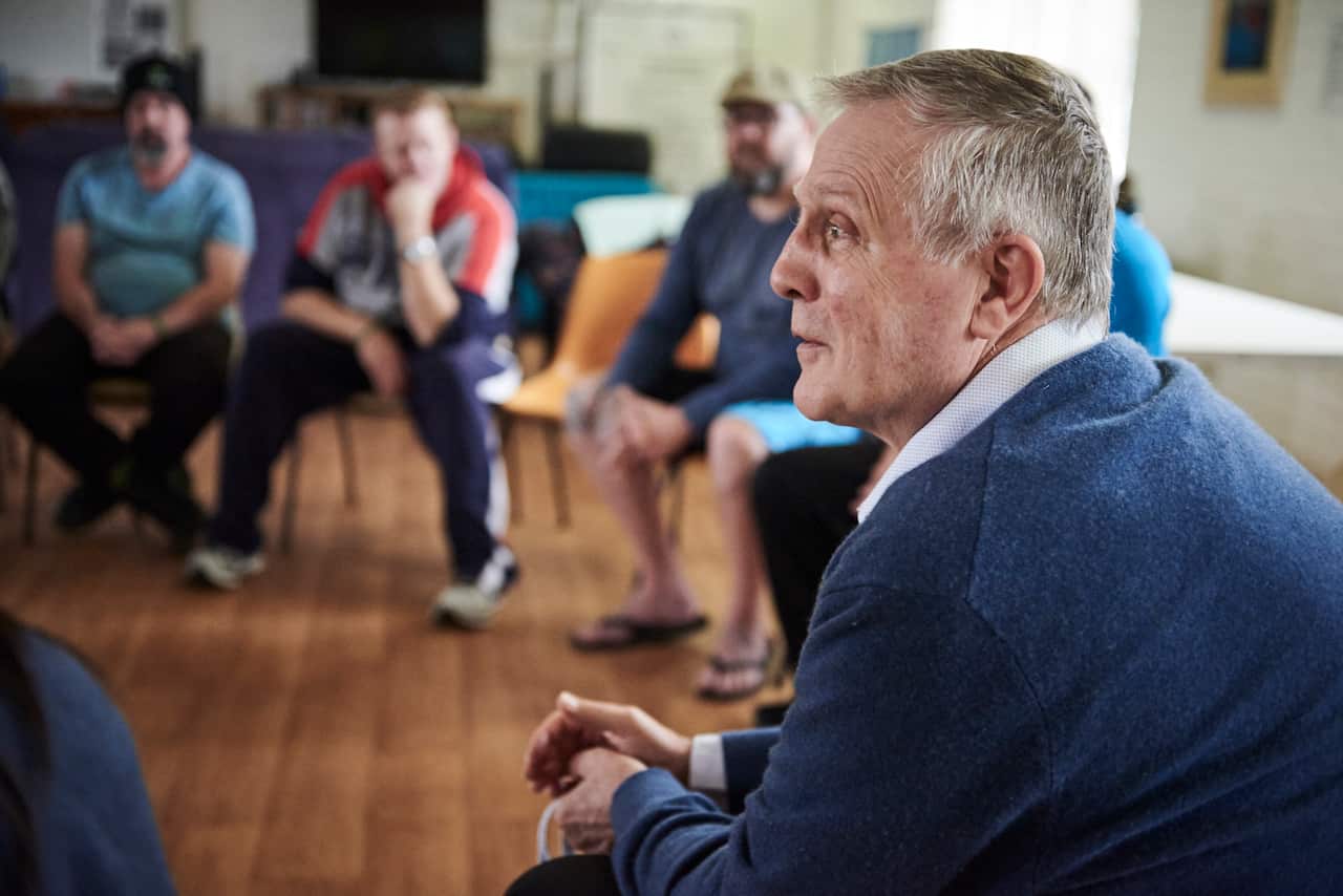 Dr. George O'Neil speaks with men residing at the Fresh Start Recovery Program in Subiaco, Australia