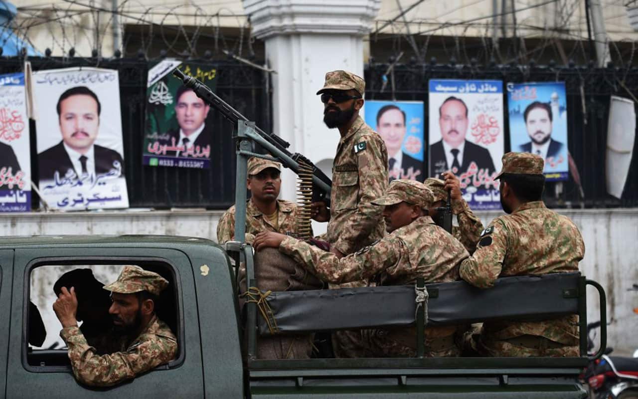 Pakistani soldiers patrol outside a voting material distribution centre in Lahore on July 24, 2018