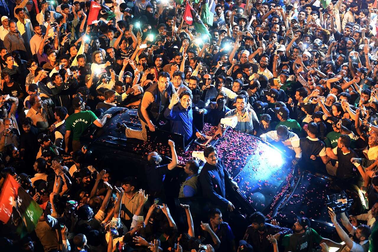 Pakistan Peoples Party (PPP) Chairman Bilawal Bhutto (C in car) waves to supporters during an election campaign rally in Karachi.