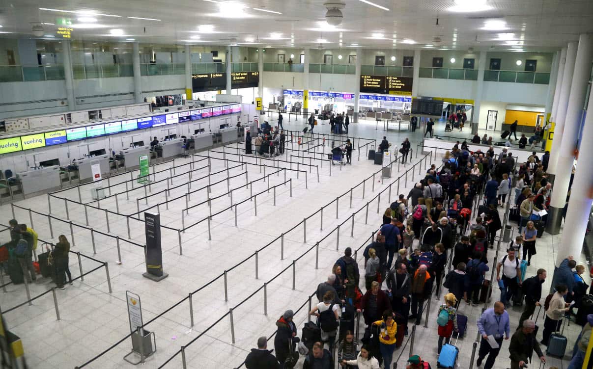 Passengers queue for flights at Gatwick Airport as the airport and airlines work to clear the backlog of flights delayed by a drone incident earlier in the week, in Crawley, England, Saturday, Dec. 22, 2018 (AAP)
