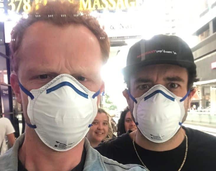 Patrick Cullen and Tel Benjamin march towards Town Hall wearing filter masks as part of the demonstration.