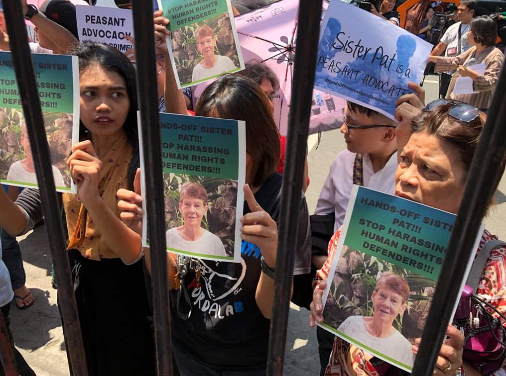 Protesters demand the release of Sister Patricia Fox outside the Philippines immigration bureau.
