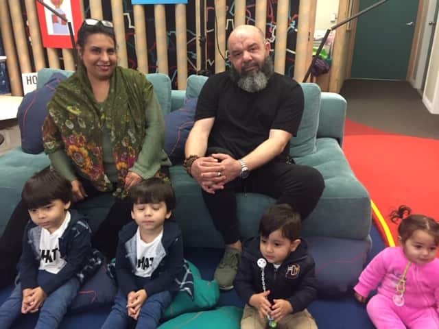 Refugees Payam Gouya and Mahwaz Giahparwar enjoy sharing Iranian stories with children.