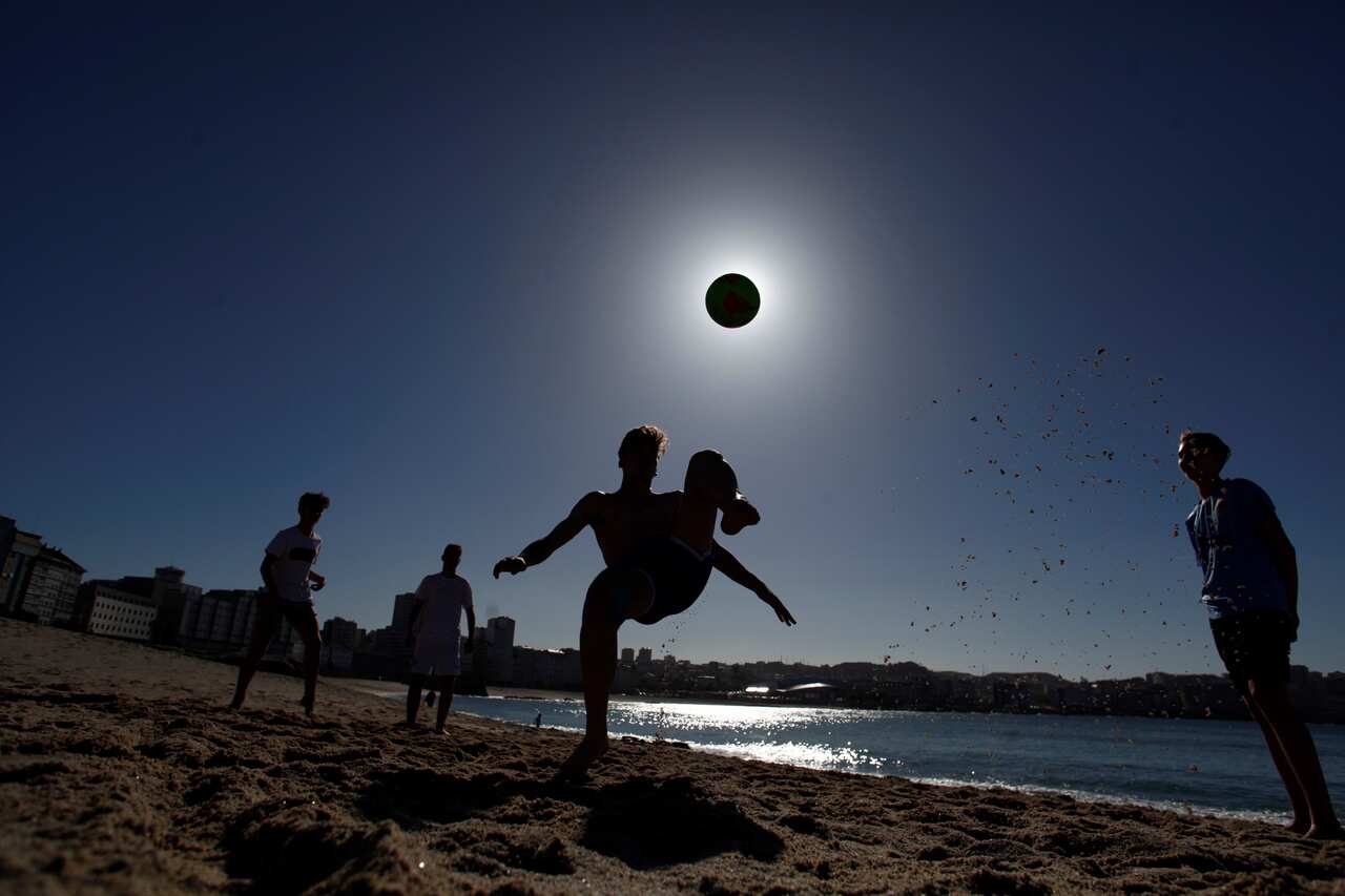 People play football at a beach in La Coruna during unrestricted times