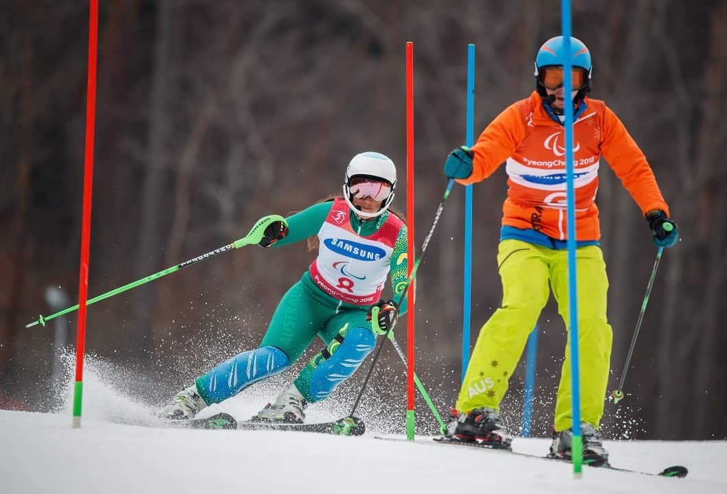 Melissa Perrine with her guide Christian Geiger competing in the Alpine Skiing Visually Impaired Women's Slalom event.