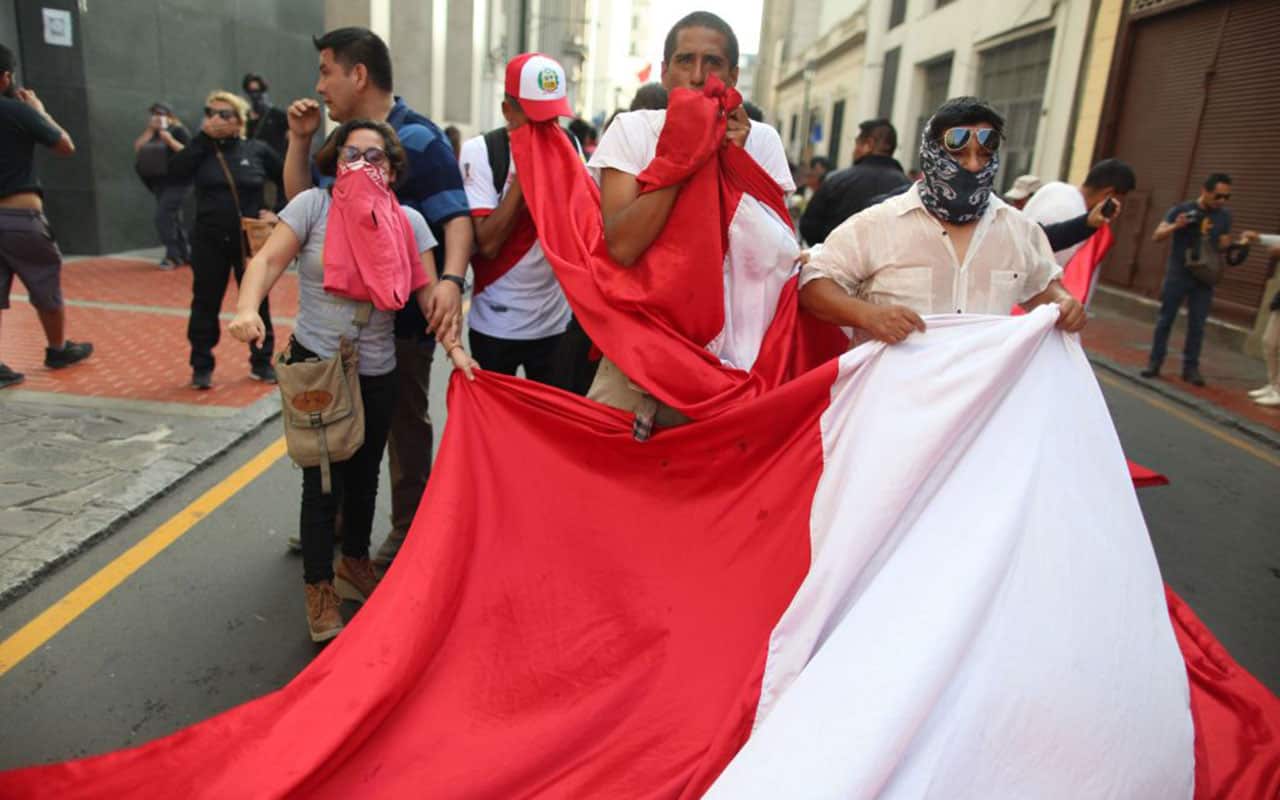 People hold a protest against Peruvian President Pedro Pablo Kuczynski's humanitarian pardon to Peru's jailed ex-president Alberto Fujimori, in Lima.