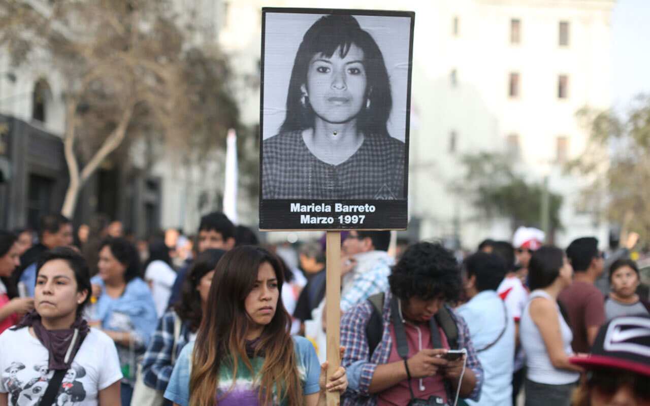 People hold a protest against Peruvian President Pedro Pablo Kuczynski's humanitarian pardon to Peru's jailed ex-president