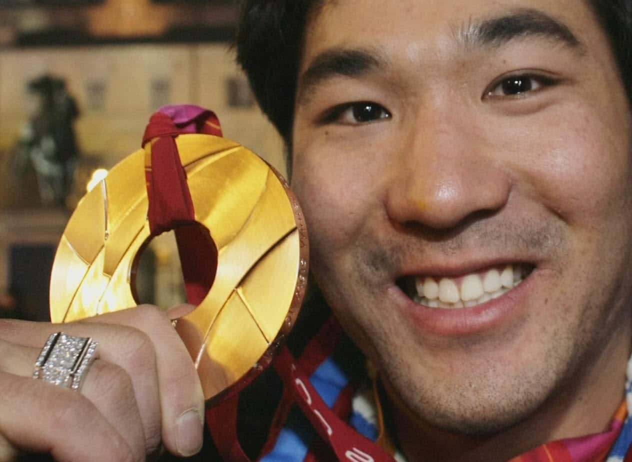 Toby Dawson shows off one of his medals.