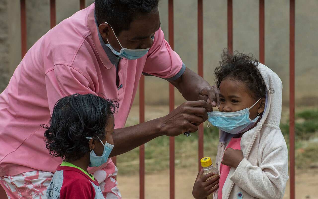Face masks are placed on children in Antananarivo, Madagascar, Tuesday, Oct. 3, 2017.