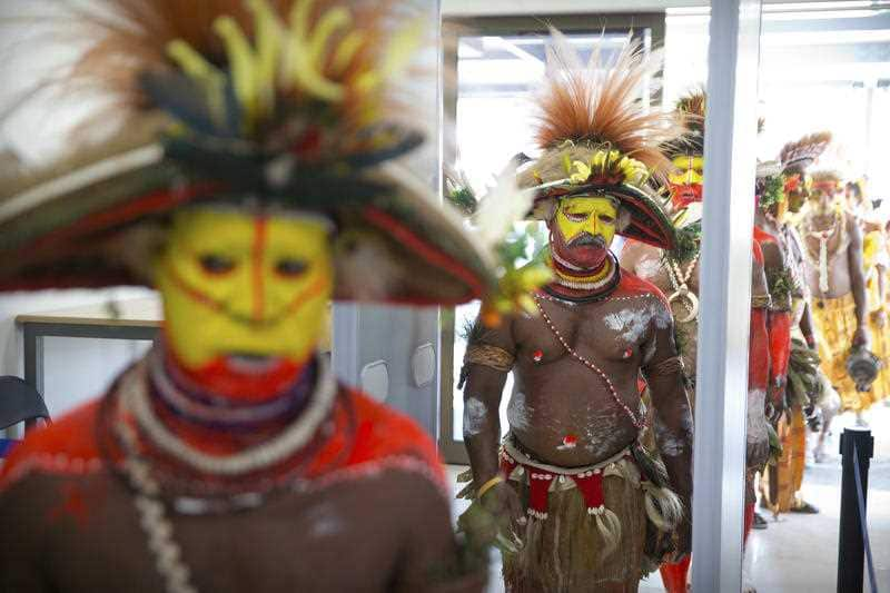 All eyes are on PNG this weekend. Performers in traditional dresses pass through a security screening at Jacksons International Airport in Port Moresby.