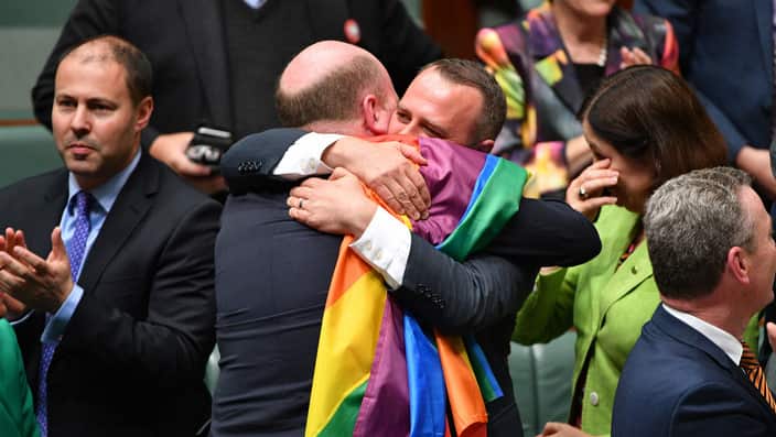 Trent Zimmerman and Tim Wilson celebrate the passing of the Marriage Amendment Bill in the House of Representatives at Parliament House.