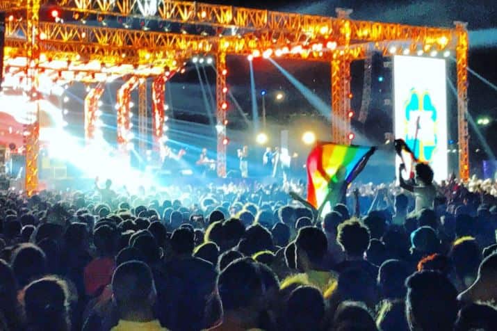 Ahmed Alaa raises the rainbow flag at a concert in Cairo in 2017. 