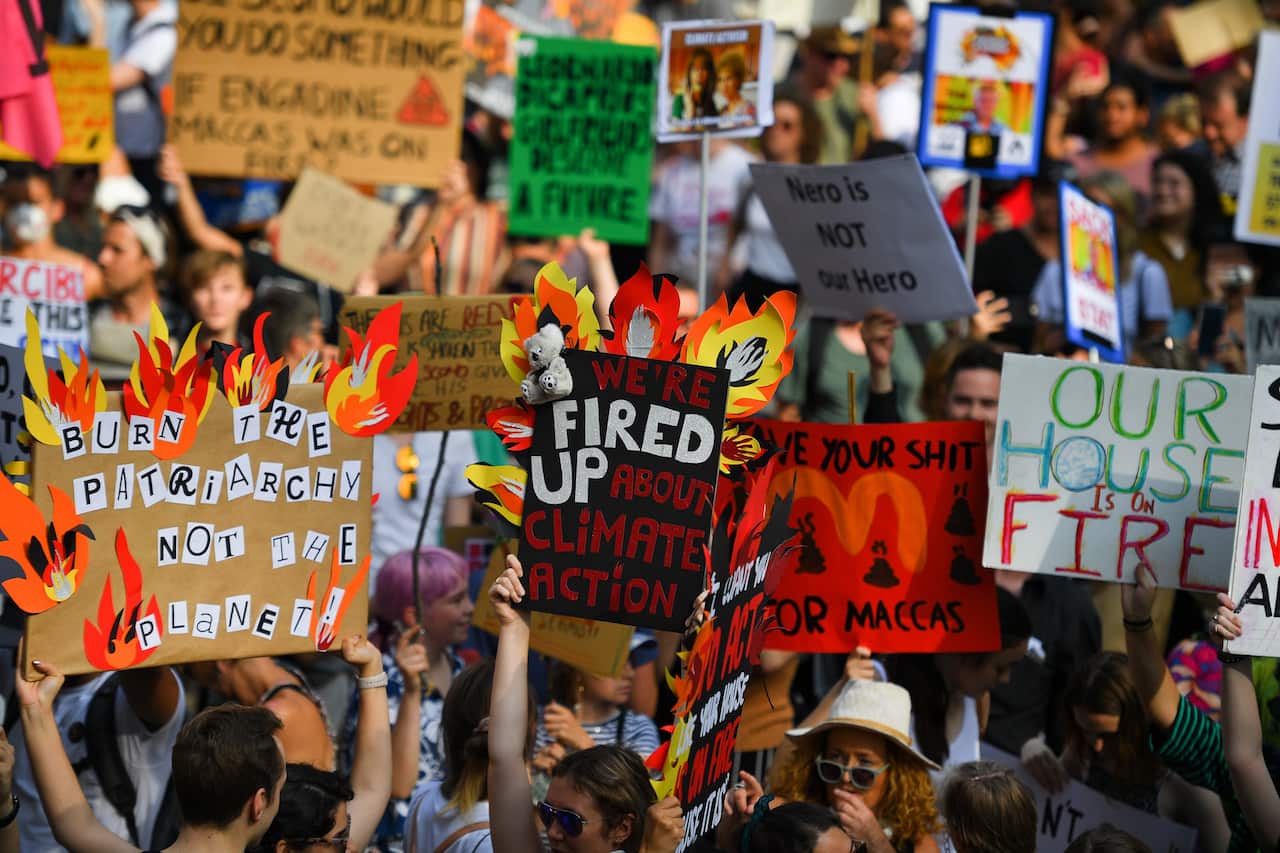 Protesters hold placards during a climate change rally in Sydney.