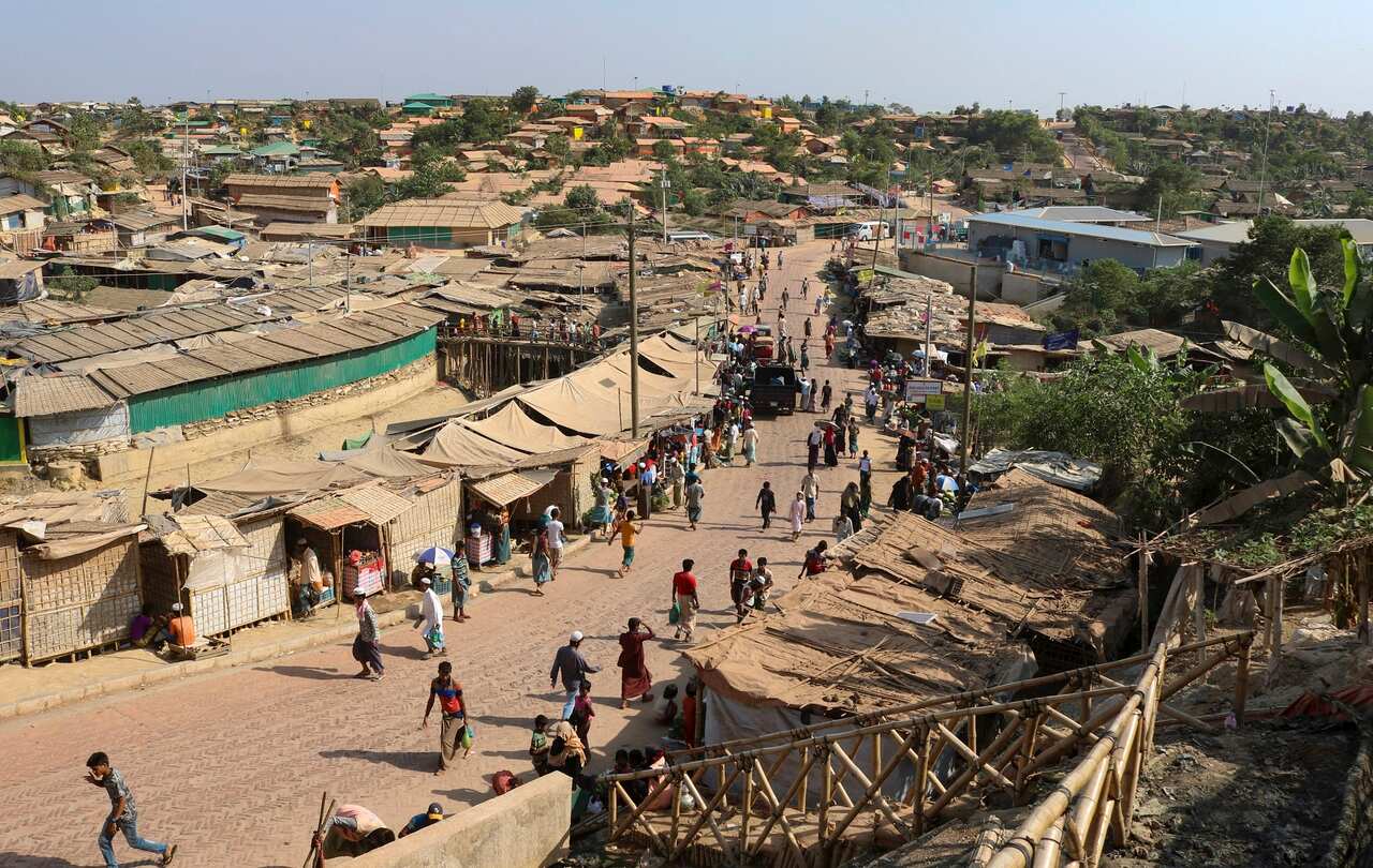Rohingya refugees walk through one of the arterial roads at the Kutupalong refugee camp in Cox's Bazar, Bangladesh. 