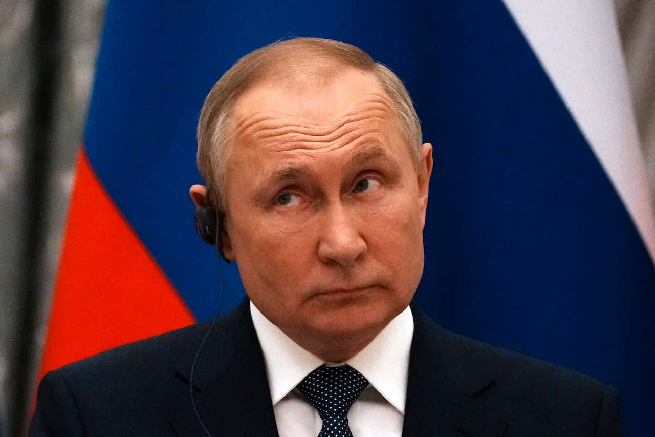 Russian President Vladimir Putin reacts during a joint press conference with French President Emmanuel Macron after their talks in Moscow on 7 February 2022.
