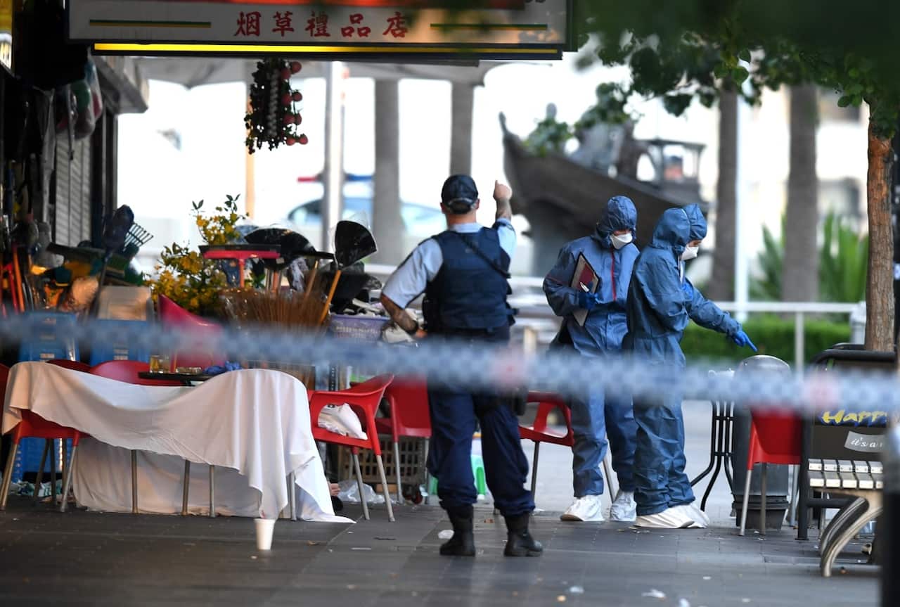 NSW Police and Forensic Services officers attend the scene of a shooting at a cafe at Bankstown City Plaza, in Bankstown, Tuesday, January 23, 2018. 