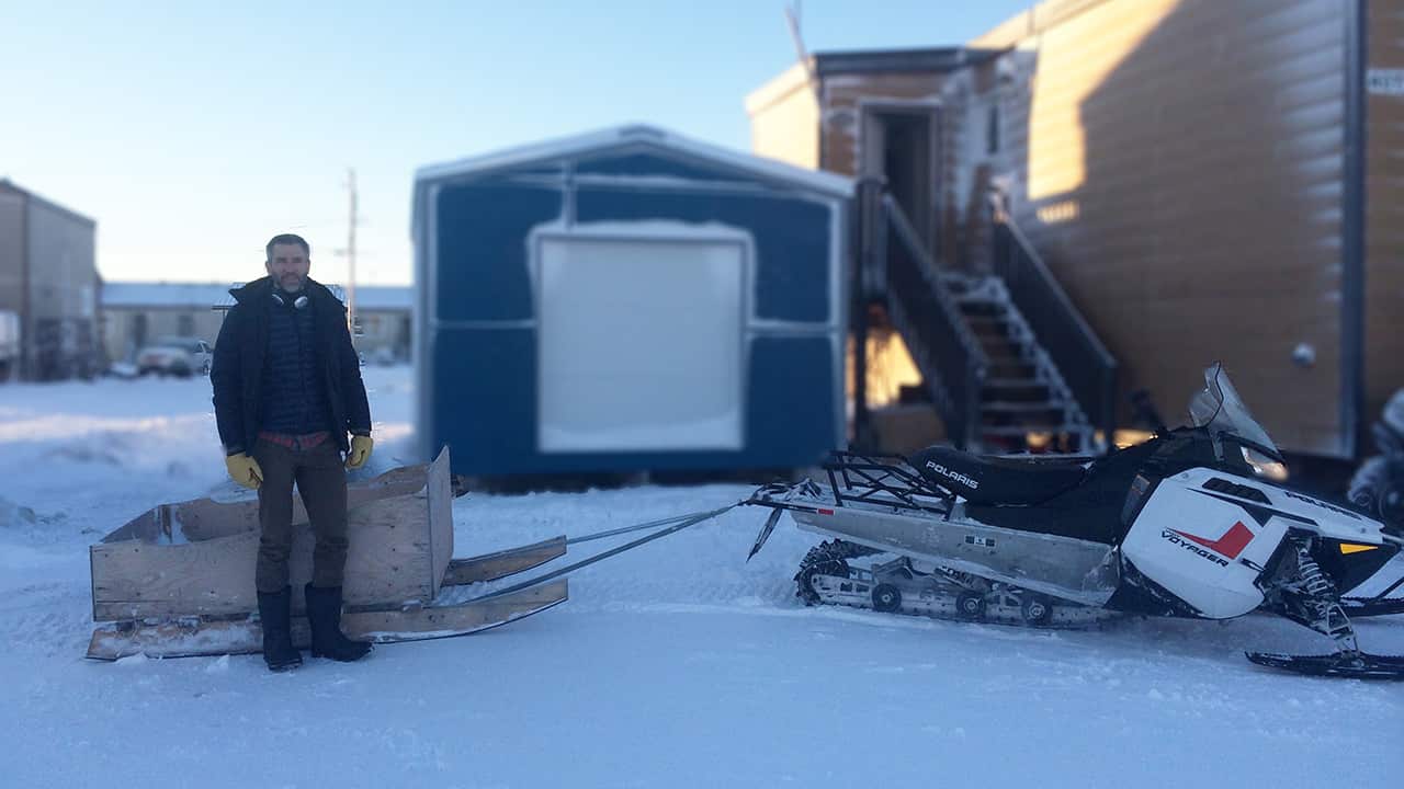 Aaron found that a snowmobile with a sled attached was the quickest way to get around, but it made for a cold and bumpy ride!