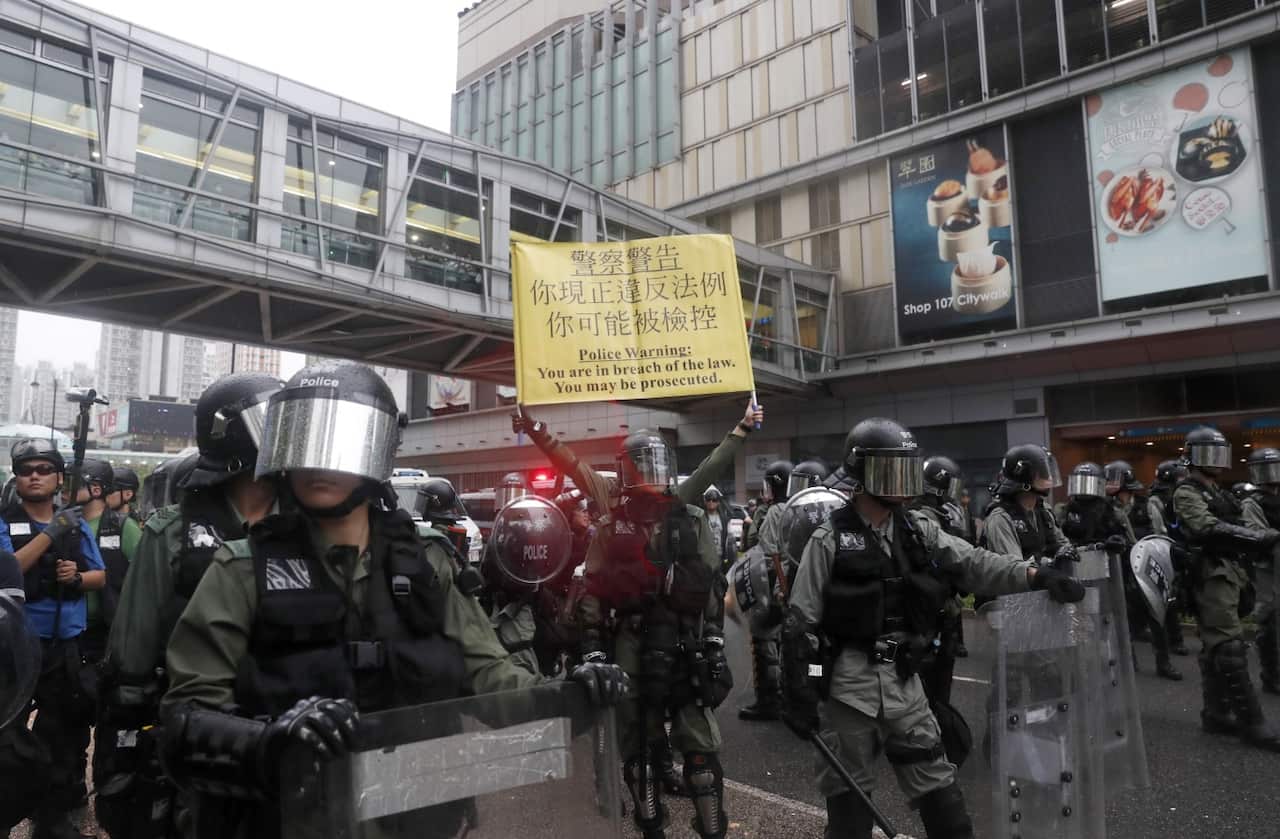 Riot police guard while protesters take part in an anti-government rally in Kwai Fung and Tsuen Wan in Hong Kong, China, 25 August 2019.