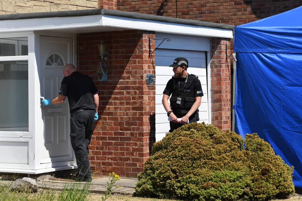 Police officer enters a house in Chester after a healthcare professional working at the Countess of Chester Hospital.