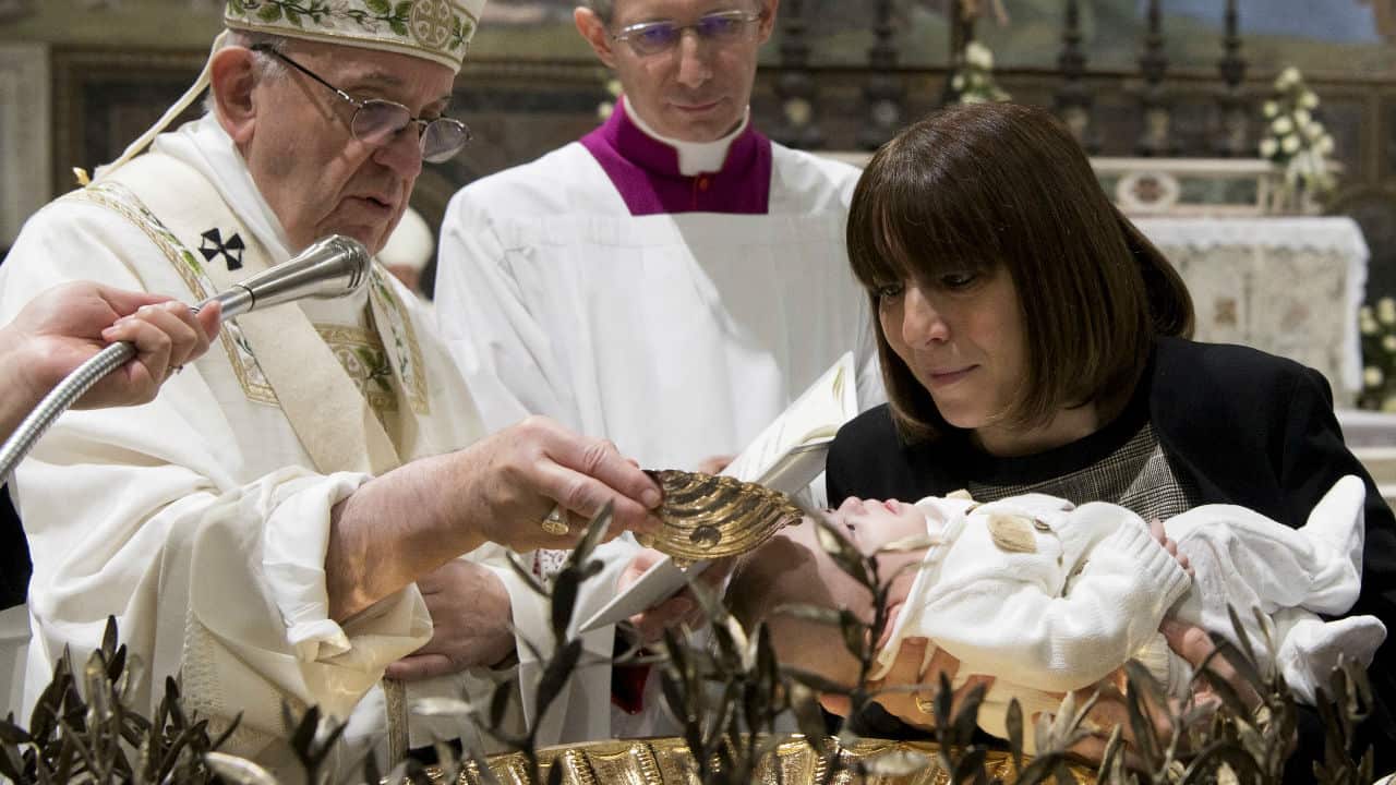 Pope Francis conducts a baptism in the Sistine Chapel.