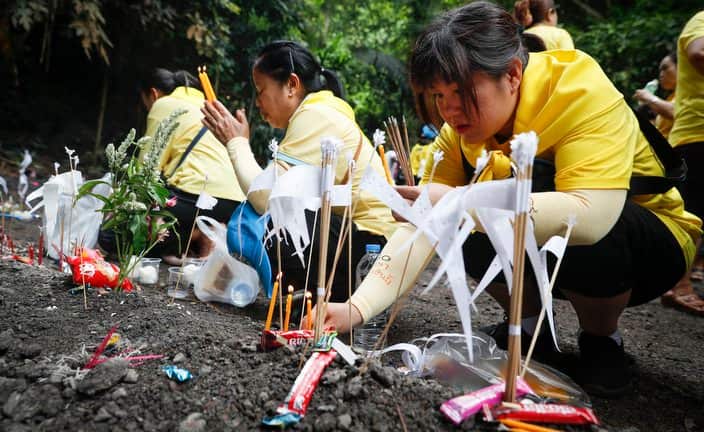 People pray during a cleansing ceremony and memorial service for former Thai navy SEAL Petty Officer Saman Gunan.