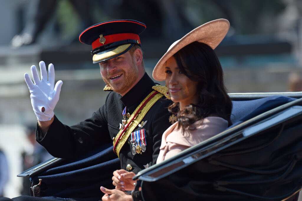 Prince Harry, Duke of Sussex and Meghan, Duchess of Sussex travel in an open carriage to the Trooping the Colour ceremony on June 09