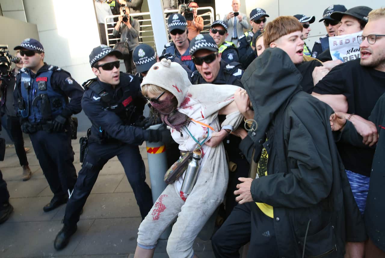 Protesters and police grapple outside the The International Mining and Resources Conference today.