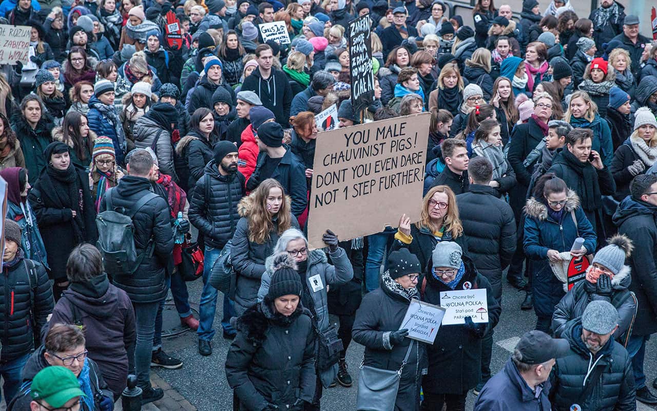 Women hold a massive sign-board during a pro-choice demonstration in front of the Polish parliament in Warsaw on March 23, 2018. 