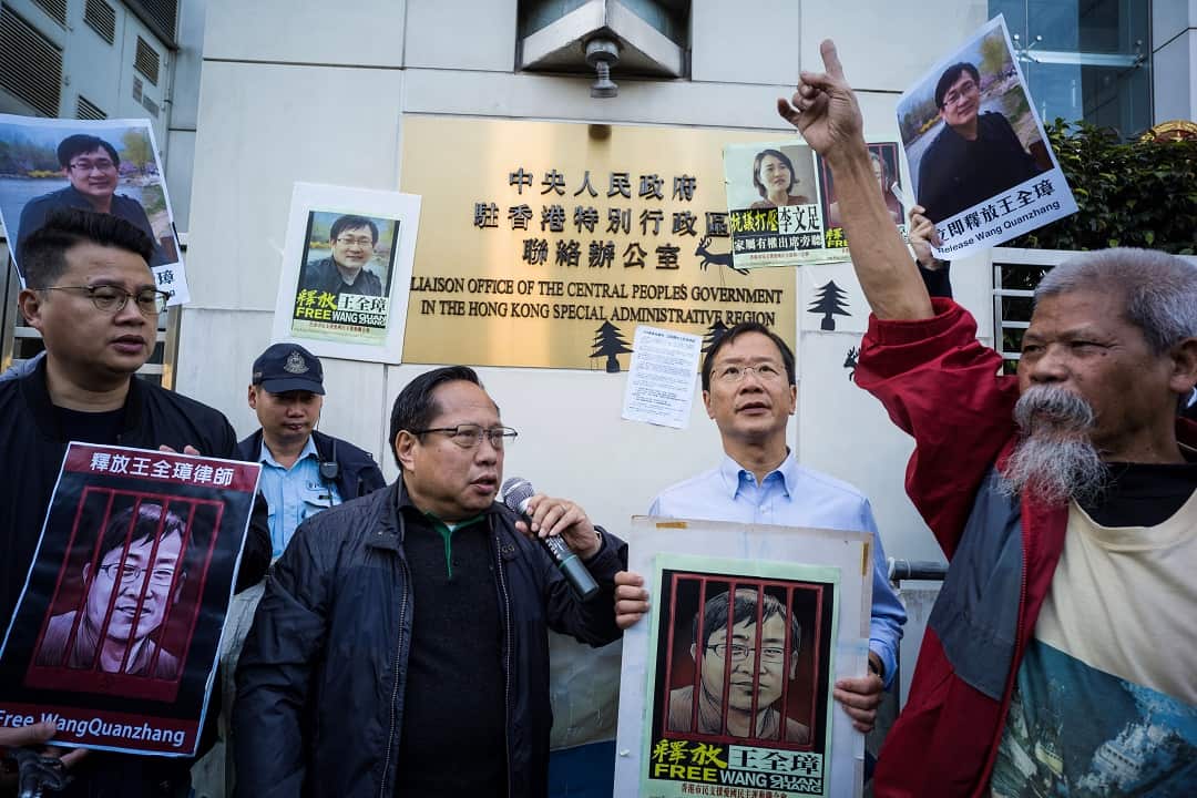 Veteran pro-democracy lawmaker Albert Ho (centre left) outside the Chinese Liaison Office in Hong Kong ahead of Wang's trial.