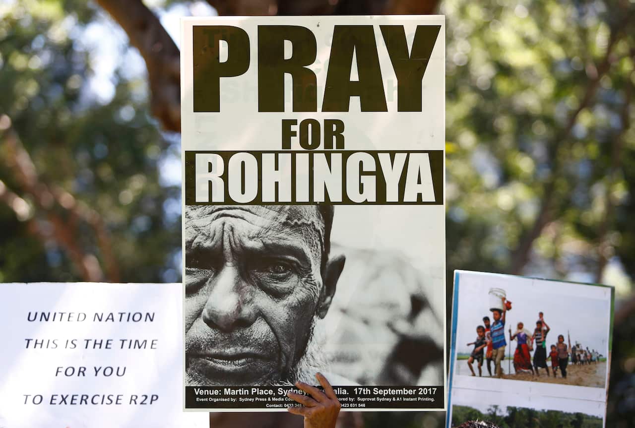 Rohingya supporters hold placards during a protest against Aung San Suu Kyi as she visits Australia to attend ASEAN Summit 2018 in Sydney, Saturday, March 17, 2018.