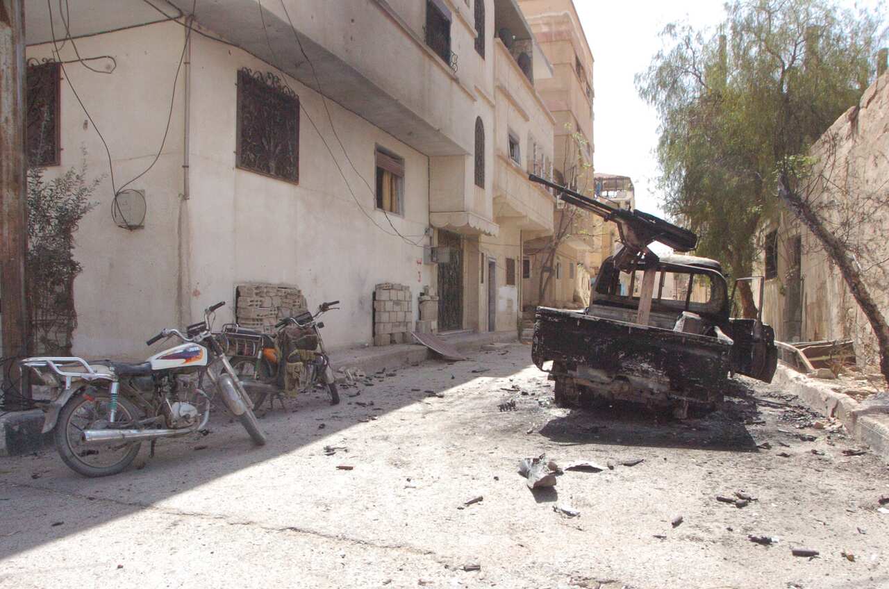 A torched machinegun-loaded vehicle is seen at one of the streets of the ancient city of Palmyra