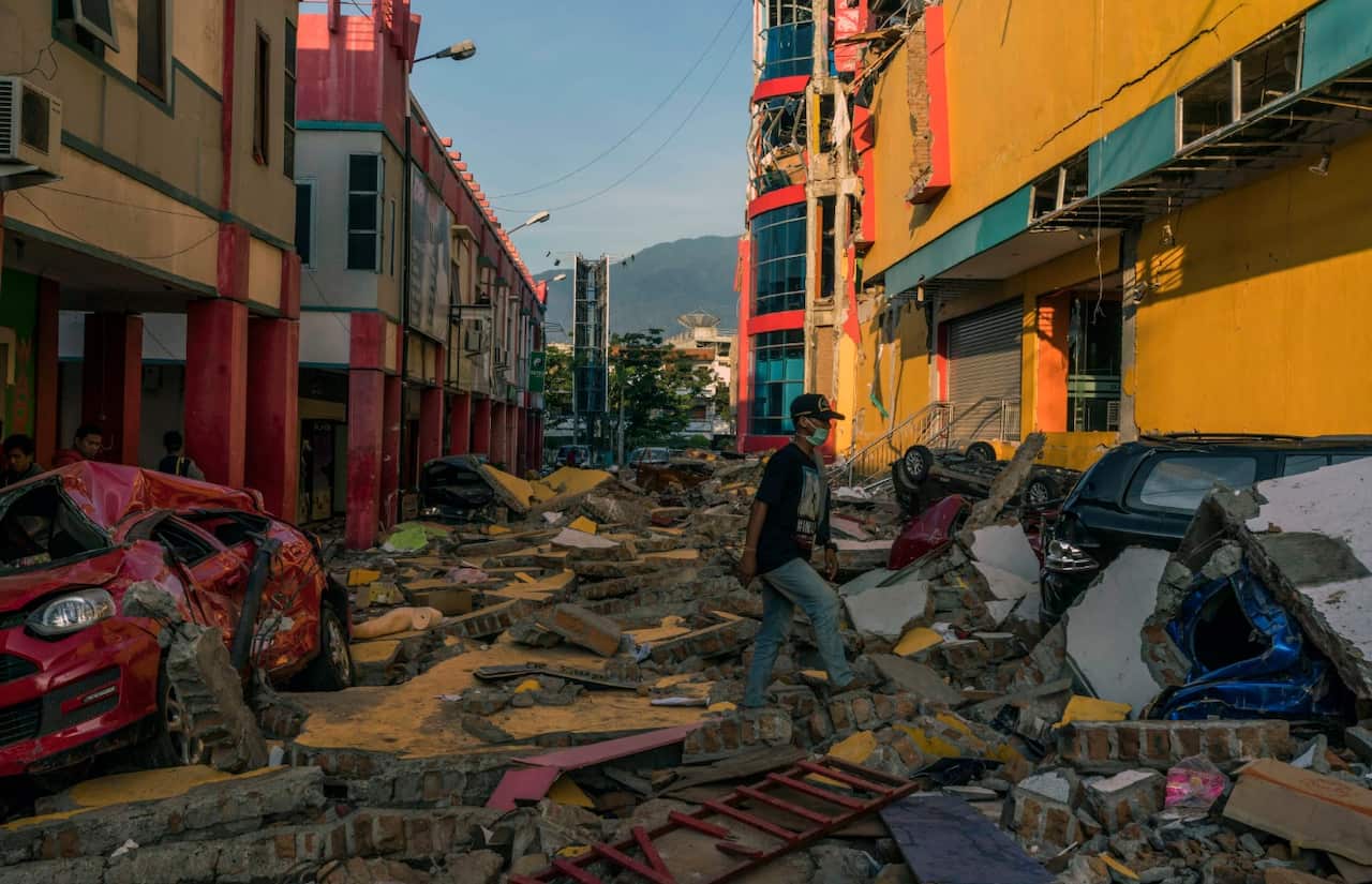 Cars buried under rubble outside the damaged Ramayana Supermarket in Palu, Indonesia, on Tuesday, Oct. 2, 2018.