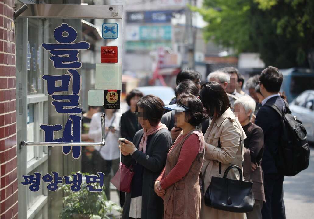 People queue at a restaurant famous for the Pyongyang-style cold noodle soup.
