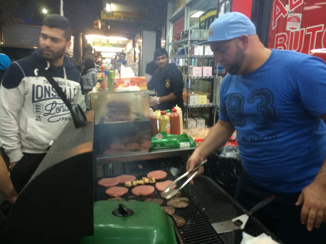 Cooking camel burgers at Lakemba's Haldon Street market (SBS)