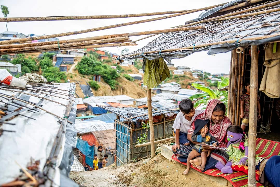 Youths with a Sesame Street doll at a Rohingya refugee camp in Bangladesh.