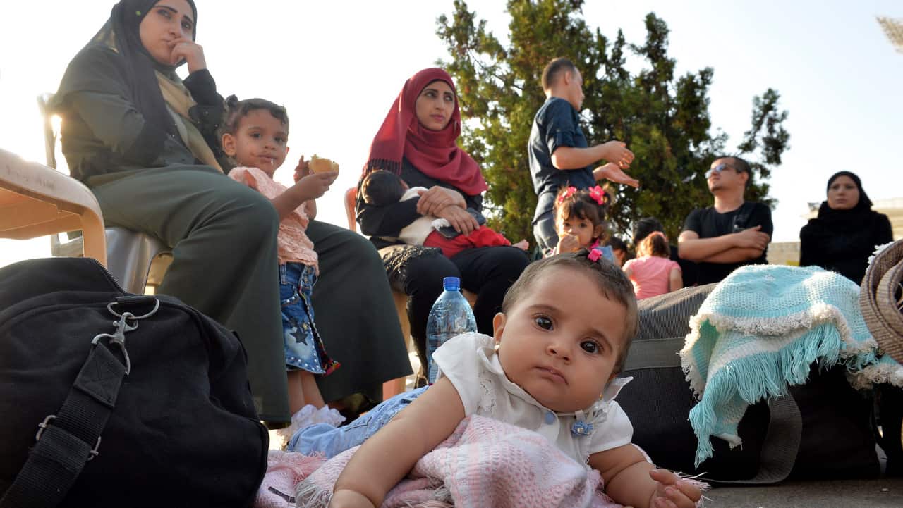 Syrian refugees gather as they prepare to leave Beirut, before their journey to their homes in Syria on 17 September 2018.