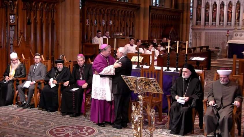 Archbishop Anthony Fisher embraces Grand Mufti Ibrahim Abu Mohammed.